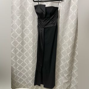 Elegant asymmetrical formal black tie floor length gown with satin sash.